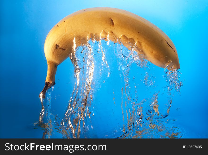 Banana in water on a blue background