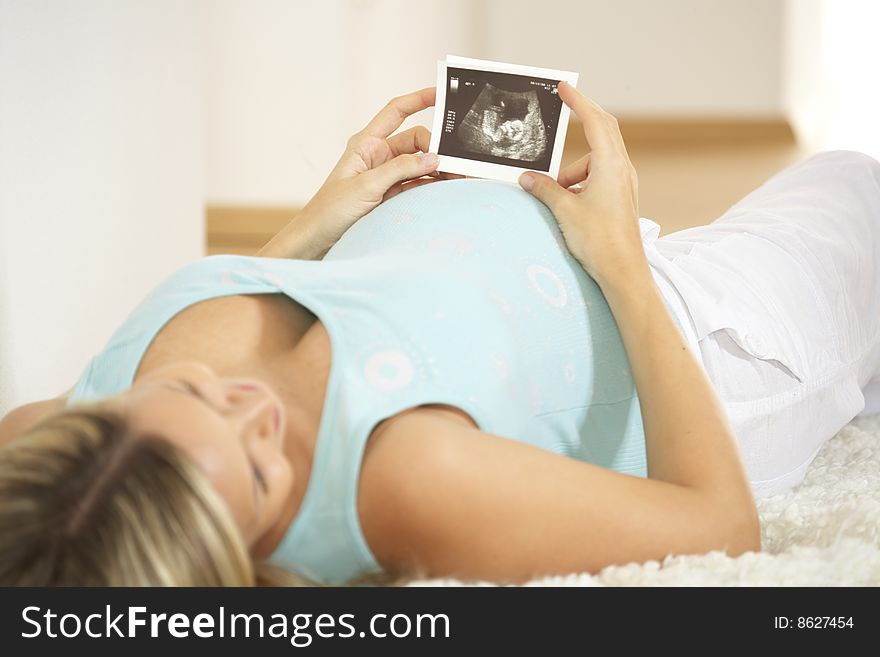 Beautiful pregnant woman with ultrasound pictures. Beautiful pregnant woman with ultrasound pictures