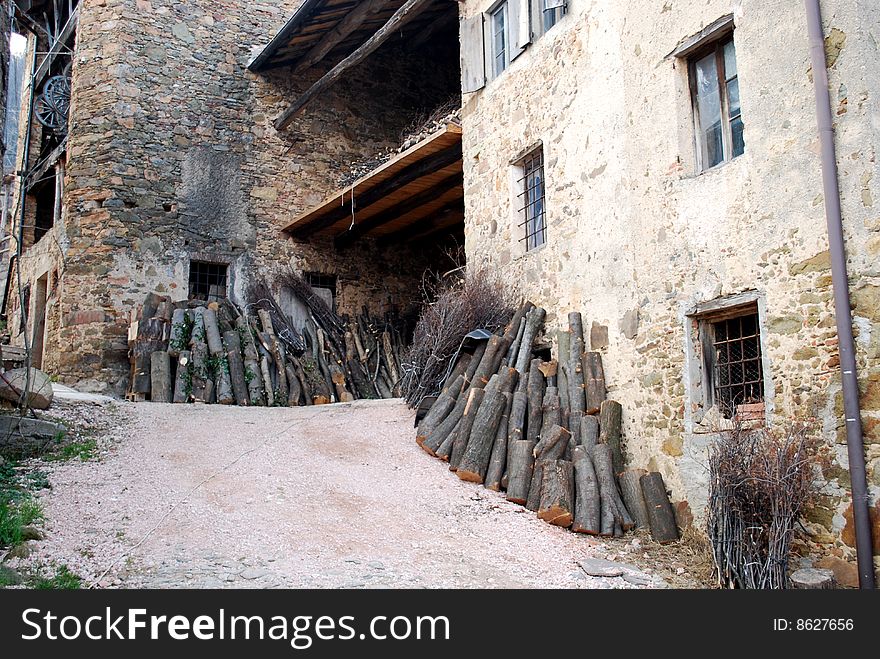 Old and ancient farm and Stacked logs s. Old and ancient farm and Stacked logs s