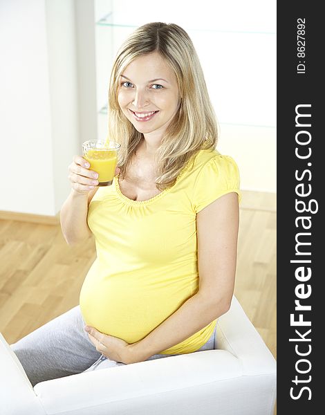 Young pregnant woman with orange juice