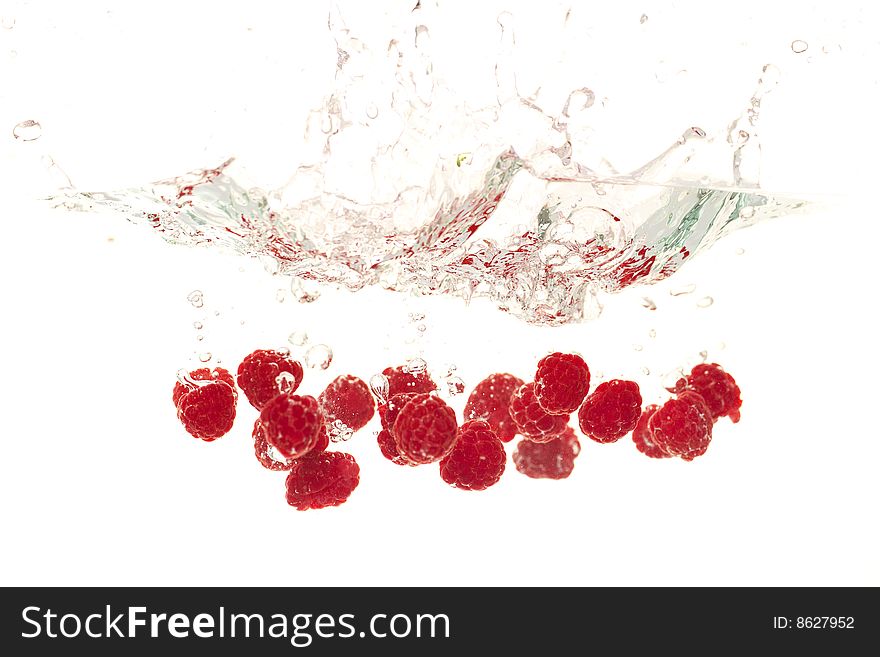 Raspberries falling into clear water. Raspberries falling into clear water