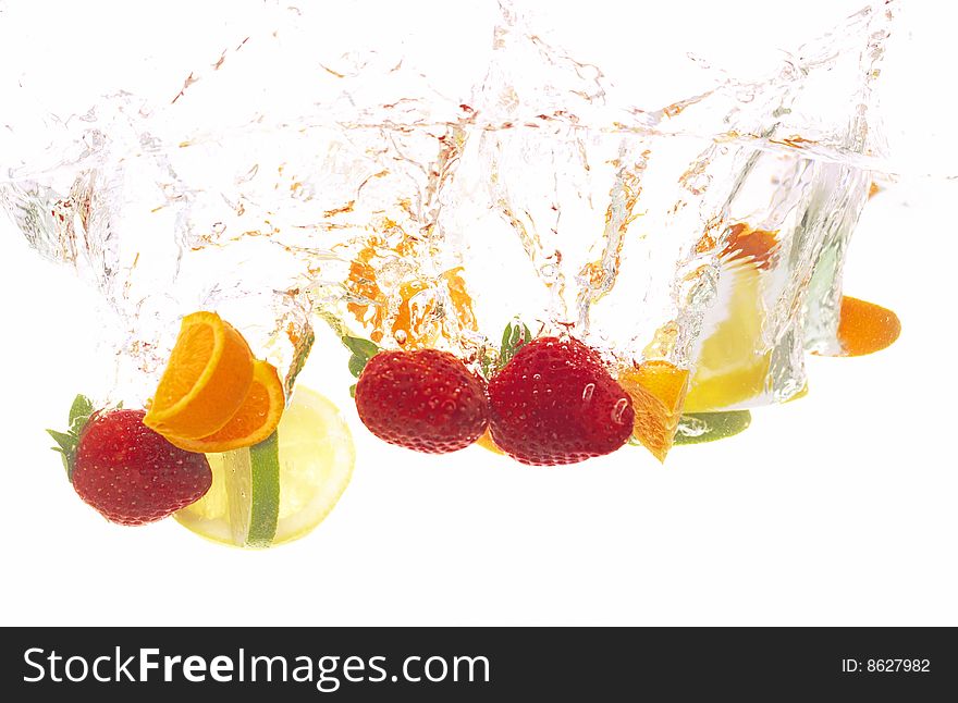Different kinds of fruits are splashing into water. Different kinds of fruits are splashing into water