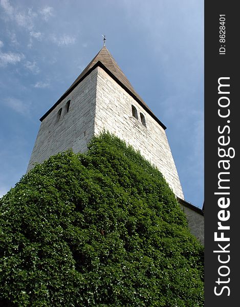 Medieval church on the island of Gotland, Sweden, green vegetation is growing up the church wall. Medieval church on the island of Gotland, Sweden, green vegetation is growing up the church wall.