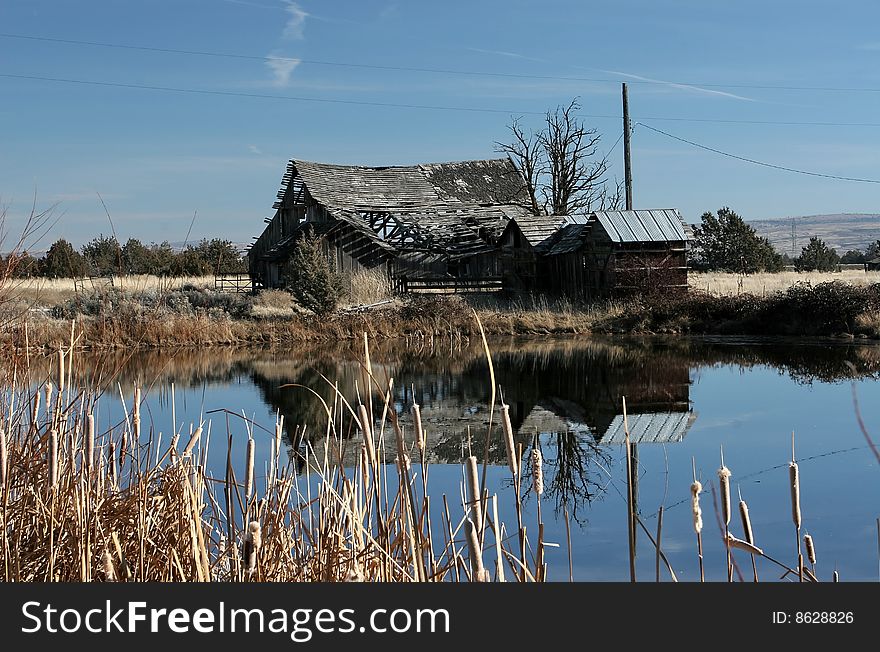 This is an old farm barn that is about to fall down and the pond is used to irrigate the wheat in the summer. This is an old farm barn that is about to fall down and the pond is used to irrigate the wheat in the summer.