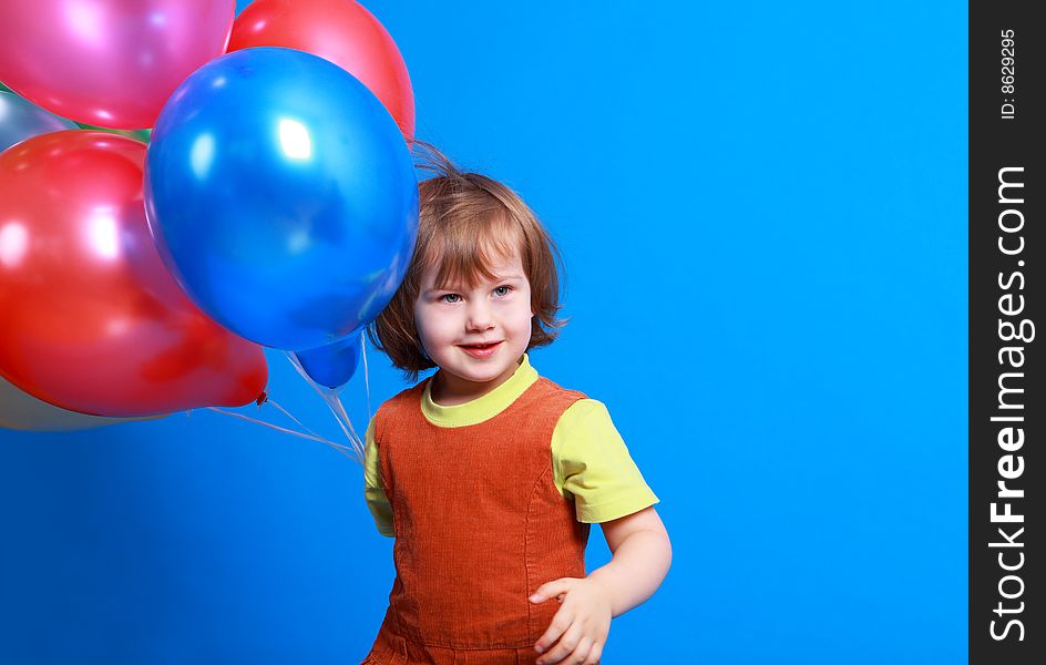 Little girl holding balloons