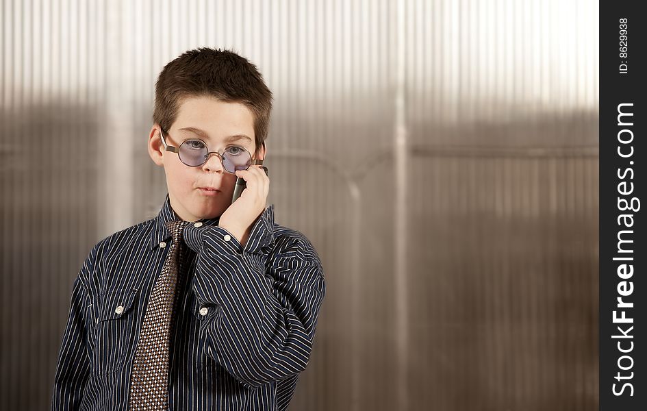 Little Boy In Adult Clothes On Cell Phone