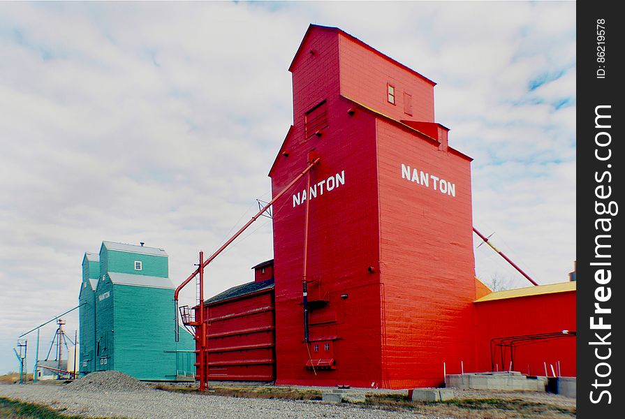 In 2001 the last of Nantonâ€™s grain elevator row was threatened by demolition because of recent abandonment of the Canadian Pacific Railway that the elevators stood next to. Many worried citizens in and around the town of Nanton had realized that a part of the town&#x27;s and province&#x27;s history was about to be torn down and lost forever. The concerned citizens of Nanton had rallied together and formed a Historical Society appropriately named &#x22;Save One&#x22;. Of course the original goal of the save one effort was to do just that, save one, but before anything could be done to save the elevator the Society had to gain full title to the land and buildings. Which was a big undertaking that would take three years to achieve. With so many volunteer hours from many local businesses and citizens, the Society was so successful that not only did they end up saving just one elevator, but all three remaining elevators. Many donations from members and surrounding farmers-ranchers, have been made and have helped in replacing the railway tracks next to the elevators the completion of many of the repairs and restorations that needed to be done on the elevators. Including painting the former Alberta Wheat Pool back to its original green and the former Pioneer elevator back to the original orange & yellow. In 2001 the last of Nantonâ€™s grain elevator row was threatened by demolition because of recent abandonment of the Canadian Pacific Railway that the elevators stood next to. Many worried citizens in and around the town of Nanton had realized that a part of the town&#x27;s and province&#x27;s history was about to be torn down and lost forever. The concerned citizens of Nanton had rallied together and formed a Historical Society appropriately named &#x22;Save One&#x22;. Of course the original goal of the save one effort was to do just that, save one, but before anything could be done to save the elevator the Society had to gain full title to the land and buildings. Which was a big undertaking that would take three years to achieve. With so many volunteer hours from many local businesses and citizens, the Society was so successful that not only did they end up saving just one elevator, but all three remaining elevators. Many donations from members and surrounding farmers-ranchers, have been made and have helped in replacing the railway tracks next to the elevators the completion of many of the repairs and restorations that needed to be done on the elevators. Including painting the former Alberta Wheat Pool back to its original green and the former Pioneer elevator back to the original orange & yellow.