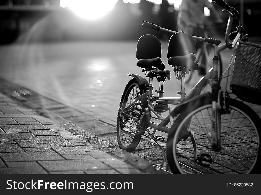 Tandem Bicycle on Sidewalk in Greyscale Photography