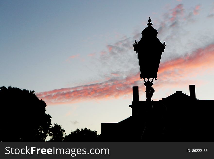 Silhouette of Street Lamp Under Clouds