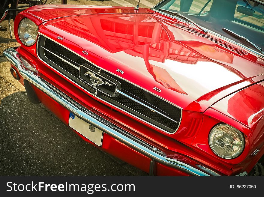 Front of a red vintage mustang motor car.