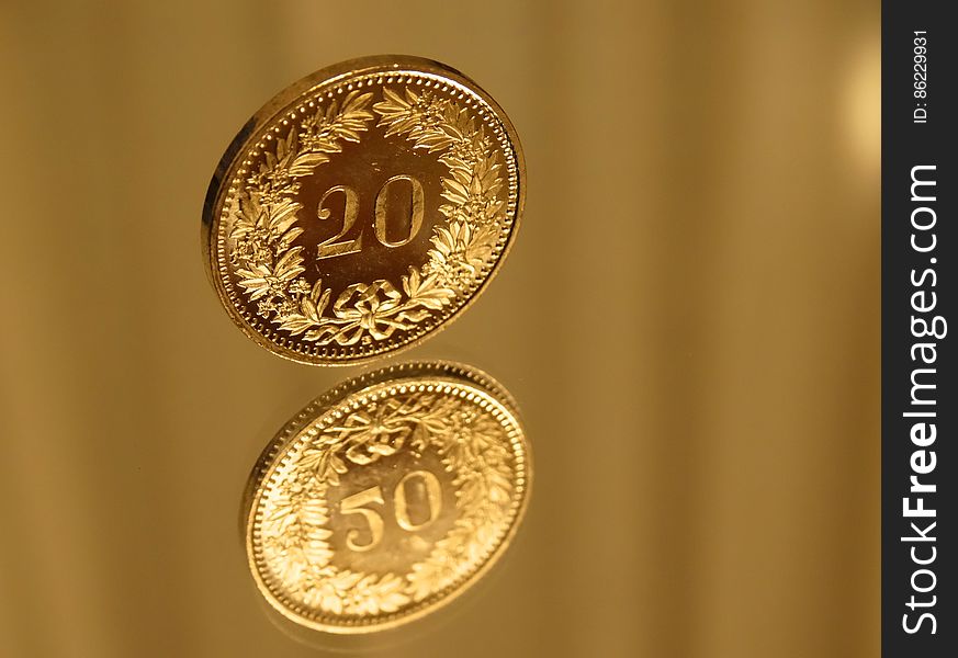 Close up of gold coin pieces on golden background. Close up of gold coin pieces on golden background.