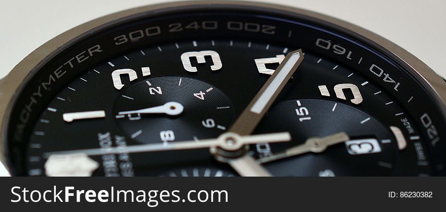 A close up of a chronograph watch on a white background.