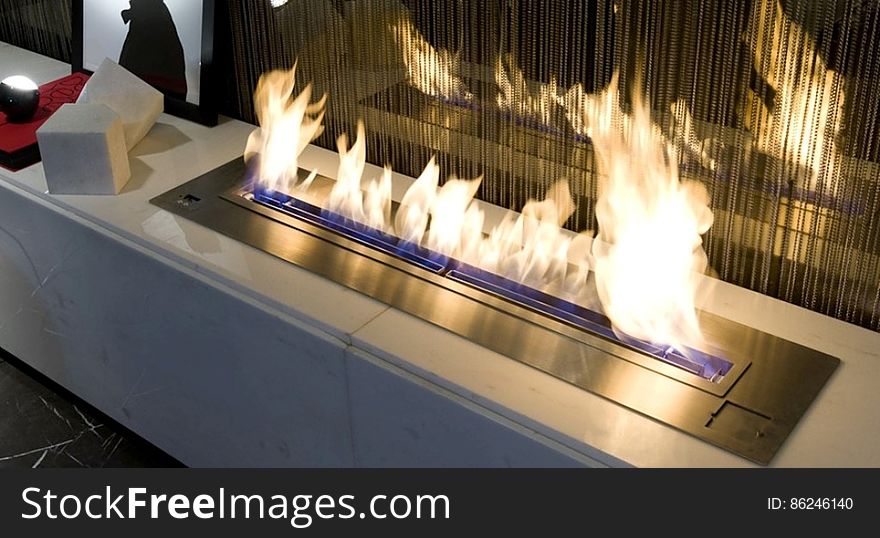 Closeup of modern bio ethanol fireplace burning in home with reflection. Closeup of modern bio ethanol fireplace burning in home with reflection.