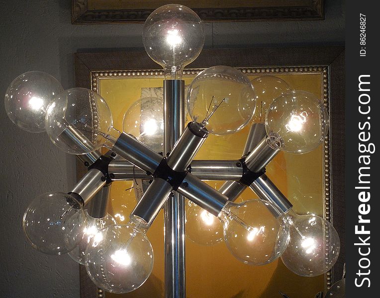 An artistic light stand with clear bulbs.