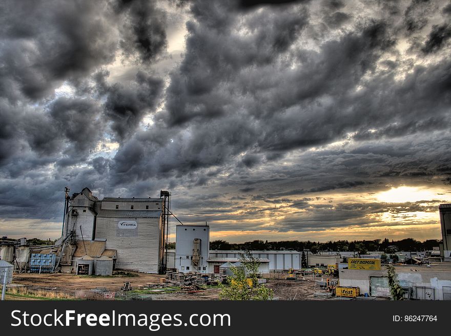 Farm buildings against stormy skies