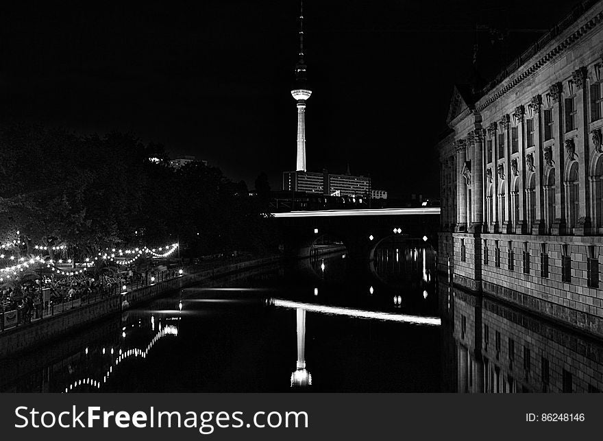 A black and white photo of Alexanderplatz in Berlin by night.