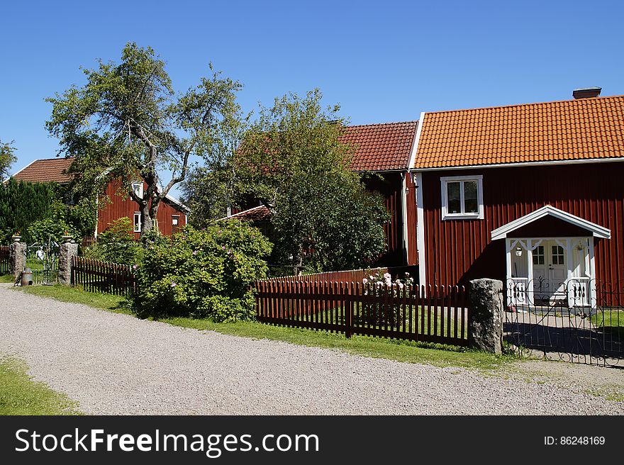 A row of neat bungalows along a street. A row of neat bungalows along a street.