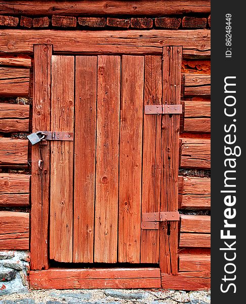 Old wooden padlocked entrance door. Old wooden padlocked entrance door.