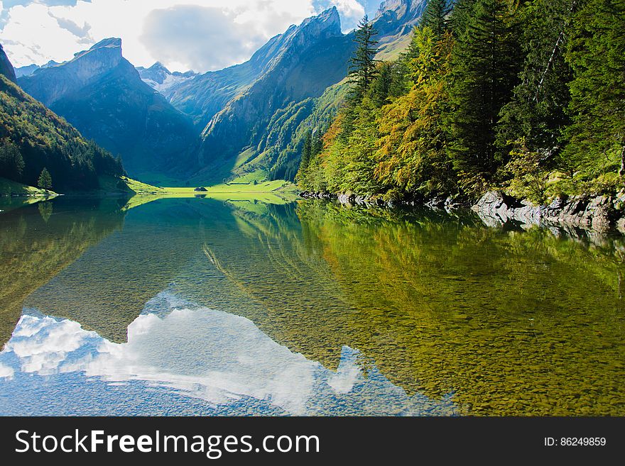 A lake in a valley in the middle of green mountains. A lake in a valley in the middle of green mountains.