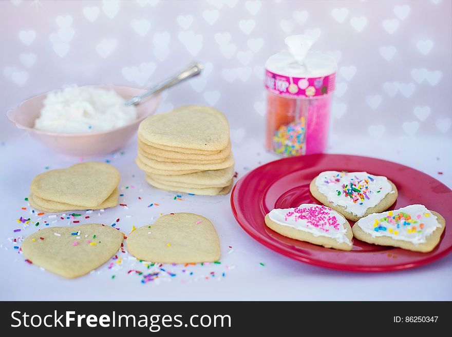 Homemade love heart biscuits with baking ingredients.