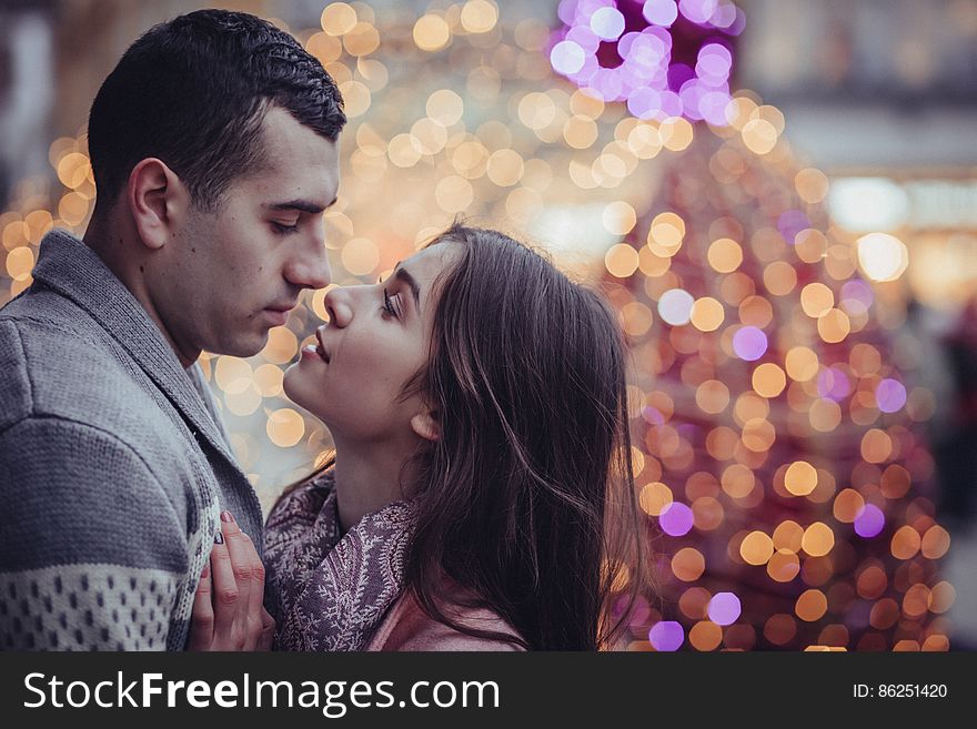 Young Couple Kissing in City at Night