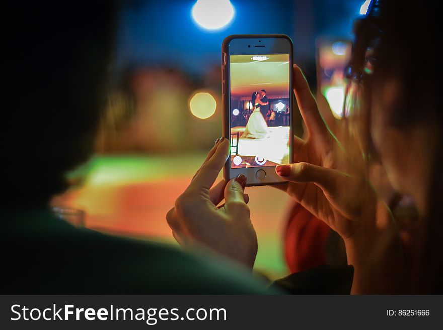 Close-up Of Woman Using Mobile Phone At Night