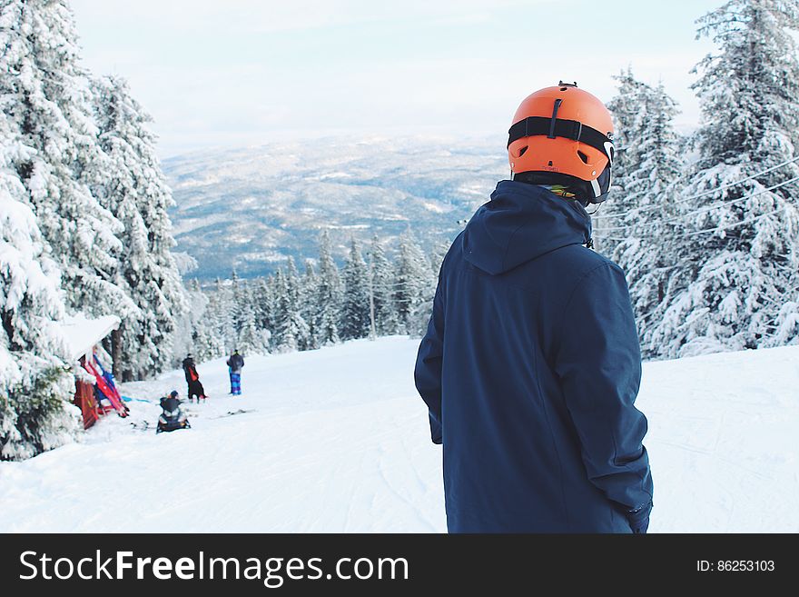 Man Standing On Snow Covered Mountain