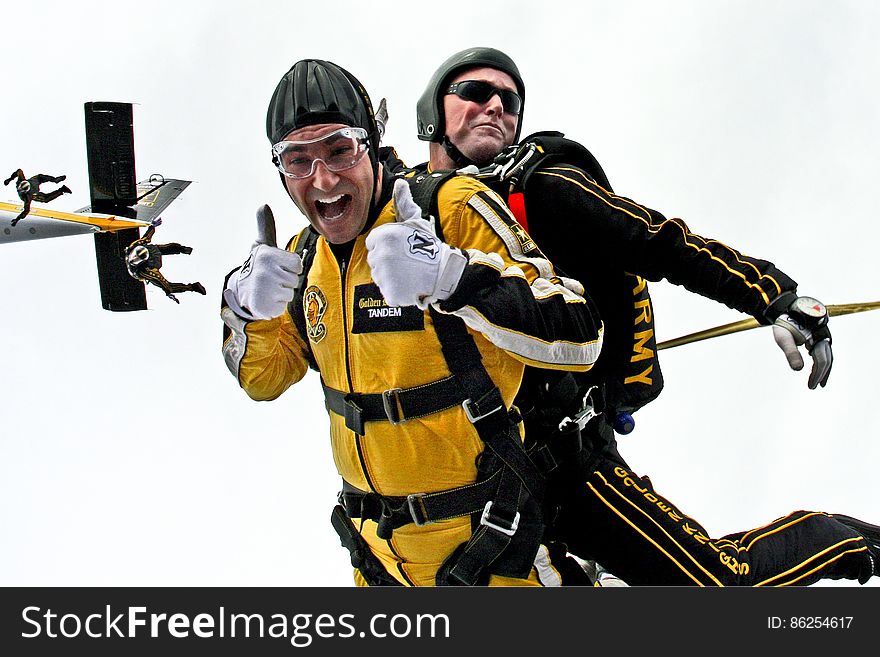 Man in Yellow Jumpsuit and Man in Black Jumpsuit Sky Diving