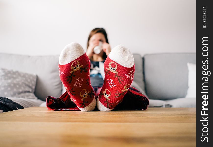 Girl On Couch Wearing Decorated Slippers