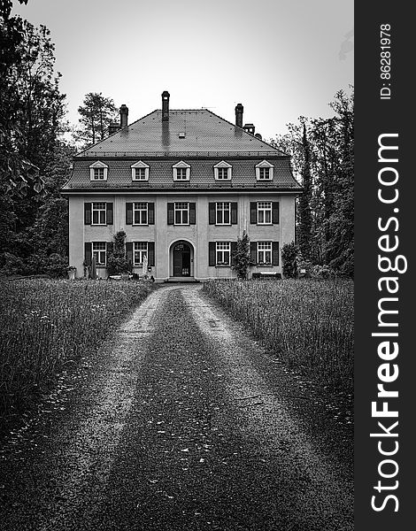 Exterior of estate home and grounds in black and white. Exterior of estate home and grounds in black and white.