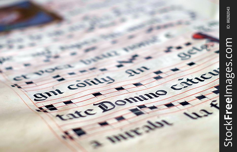Close up of medieval musical score on antique parchment paper.