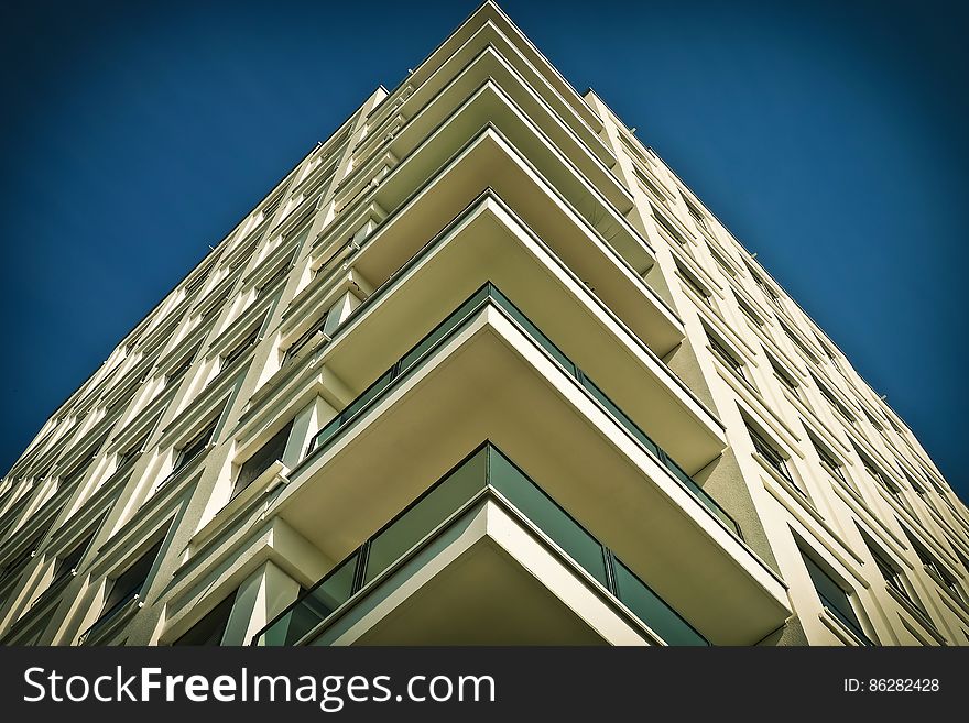 Balconies on a tall modern residential building from low angle. Balconies on a tall modern residential building from low angle.