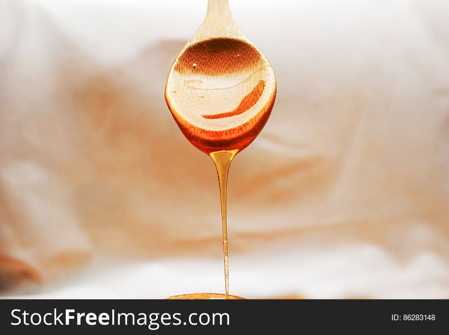Spoon With Honey Draining From It