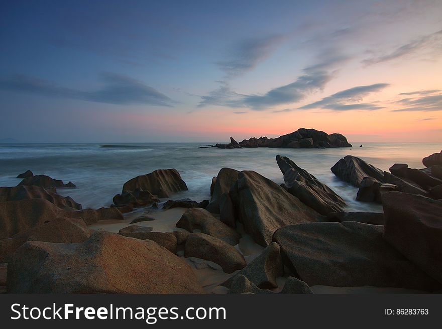 Rocks On Beach At Sunset