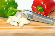 Peppers, Garlic Cloves And Press Royalty Free Stock Photos Peppers, Garlic Cloves And Press Royalty Free Stock Photos