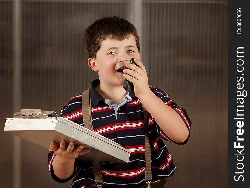 Little Boy In Adult Clothes On Cell Phone