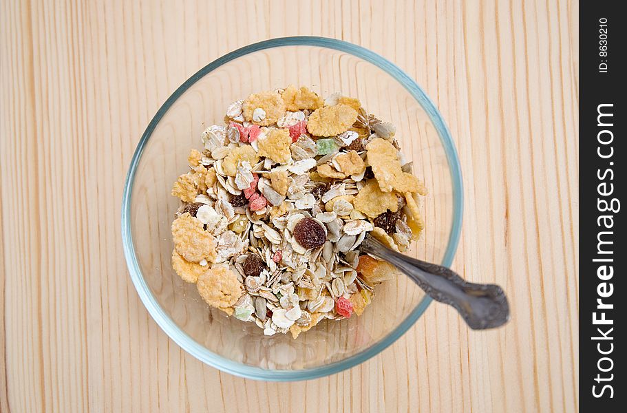 Dish with muesli on wooden table