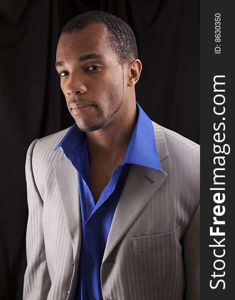 A man of african descent dressed casually with a suit jacket on. A man of african descent dressed casually with a suit jacket on.