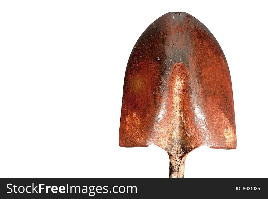 A horizontal view of an old steel gardening shovel covered with red clay dirt