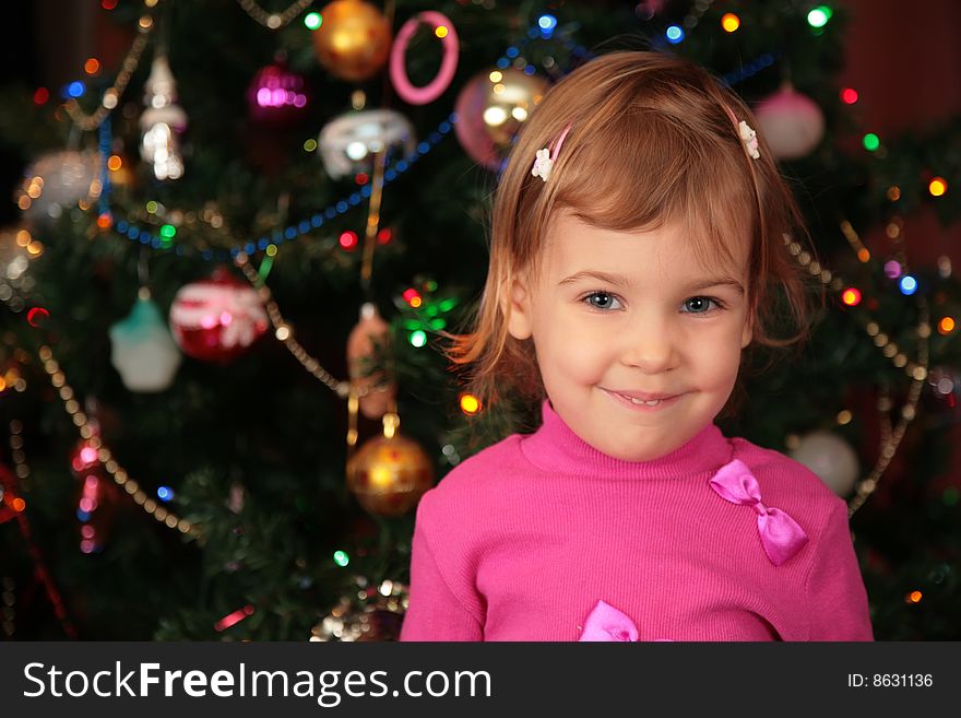 Christmas fir and smiling little girl. Christmas fir and smiling little girl