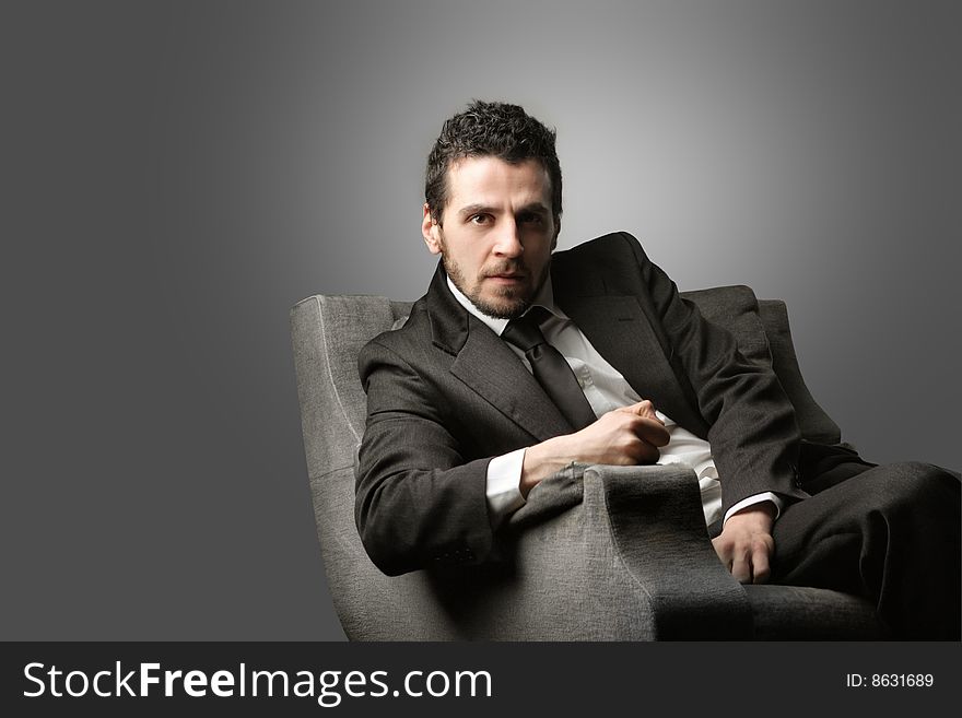 Young businessman sitting on an armchair