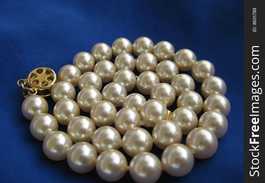 Pearl bead on dark blue fabric