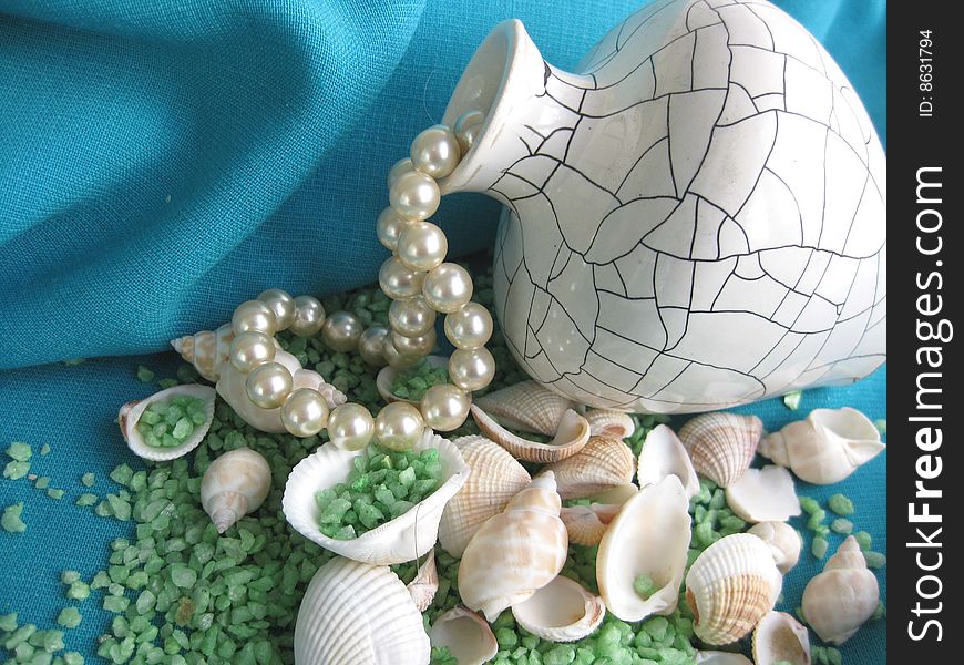 Still life. Vase, seashells and pearl bead