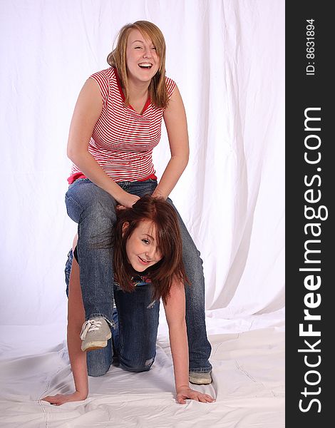 Two teen sisters fooling around in the studio. Two teen sisters fooling around in the studio