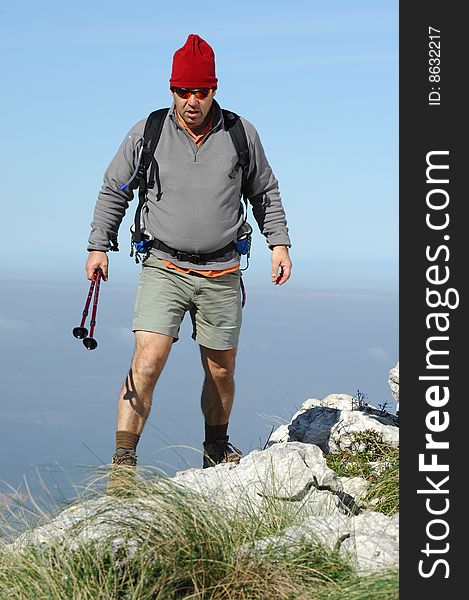 Man in a top of a in mountain hiking