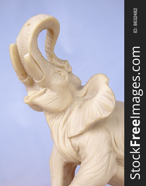 Elephant figurine isolated on a light blue background