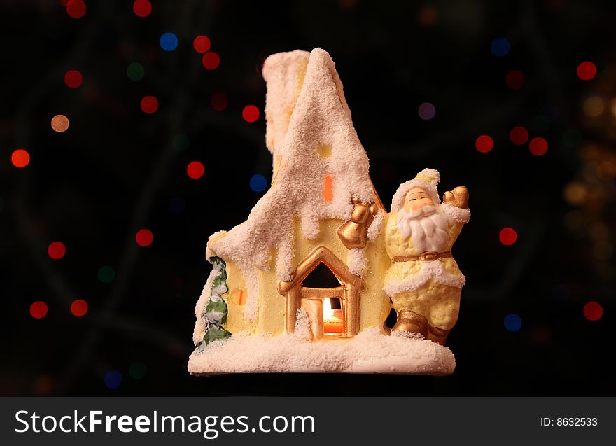 Toy small house with Santa Claus on dark