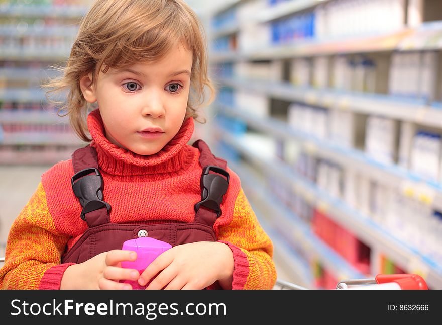 Little girl  in shop of household cosmetics