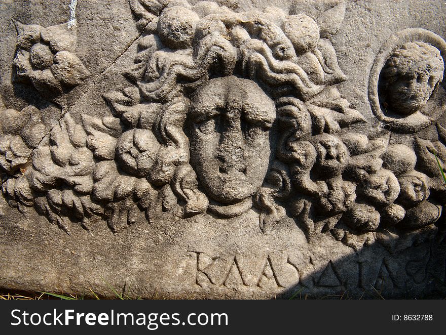 An ancient Greek Sarcophagus, featuring the carved head of a woman and the name Klaudia written in Greek. Church of St John, Selcuk, Turkey. An ancient Greek Sarcophagus, featuring the carved head of a woman and the name Klaudia written in Greek. Church of St John, Selcuk, Turkey