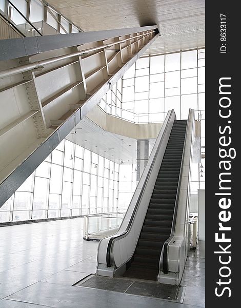 Glass hall with escalator, modern interior